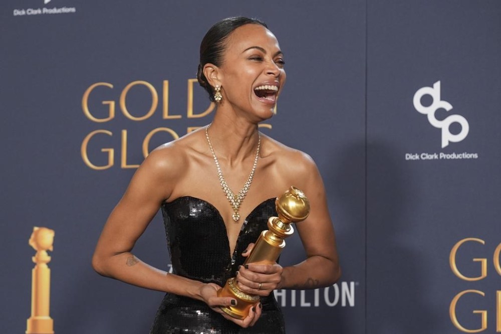 Zoe Saldana poses in the press room with the award for best performance by a female actor in a supporting role in any motion picture for