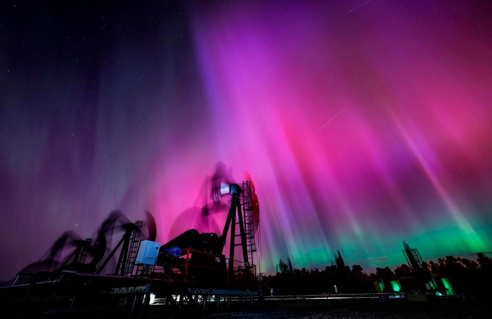 Statistics Canada says the country's merchandise trade deficit with the world was $323 million in November.The Northern Lights, aurora borealis, make an appearance over pumpjacks as they draw out oil and gas from wellheads near Cremona, Alta., Thursday, Oct. 10, 2024. THE CANADIAN PRESS/Jeff McIntosh