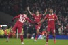 Liverpool's Cody Gakpo, center, celebrates after scoring his side's first goal against Manchester United during the English Premier League soccer match at the Anfield stadium in Liverpool, England, Sunday, Jan. 5, 2025. (AP Photo/Jon Super)