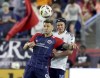 New England Revolution forward Giacomo Vrioni, left, and Vancouver Whitecaps defender Bjørn Inge Utvik, right, head the ball during the second half of an MLS soccer match in Foxborough, Mass., on June 15, 2024. THE CANADIAN PRESS/AP - Mark Stockwell