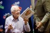 FILE - Former President Jimmy Carter hands a copy of his new book, 