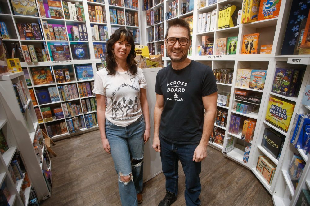 JOHN WOODS / FREE PRESS
Hilary James, general manager of Across the Board Game Café with co-owner Clinton Skibitzky. Skibitzky, like other local retailers, hasn't noticed a big sales impact from the GST break.