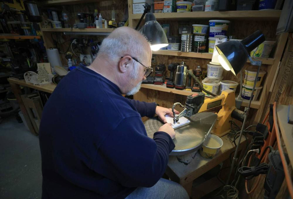 RUTH BONNEVILLE / FREE PRESS
Throughout the year, Lowe buys wood, creates designs, cuts them out, and gives them a quick buff with sandpaper. In December, he delivers them to be put into hampers.