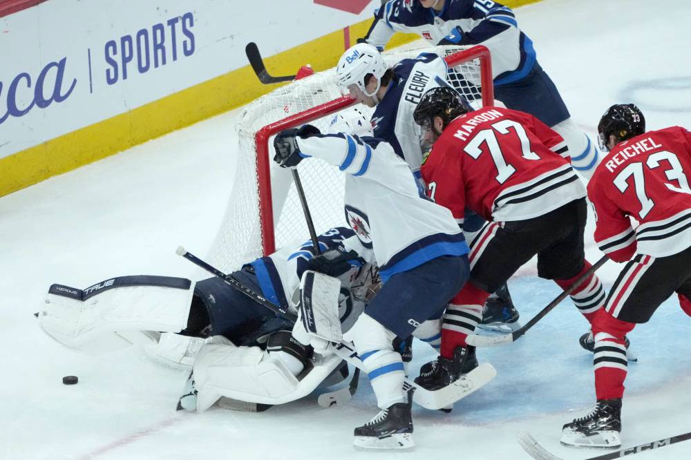 CHARLES REX ARBOGAST / THE ASSOCIATED PRESS
The puck gets loose after Winnipeg Jets’ goaltender Connor Hellebuyck makes a save in the third period of an NHL game against the Chicago Blackhawks on Saturday, Dec. 7, 2024, in Chicago. The Jets won 4-2.