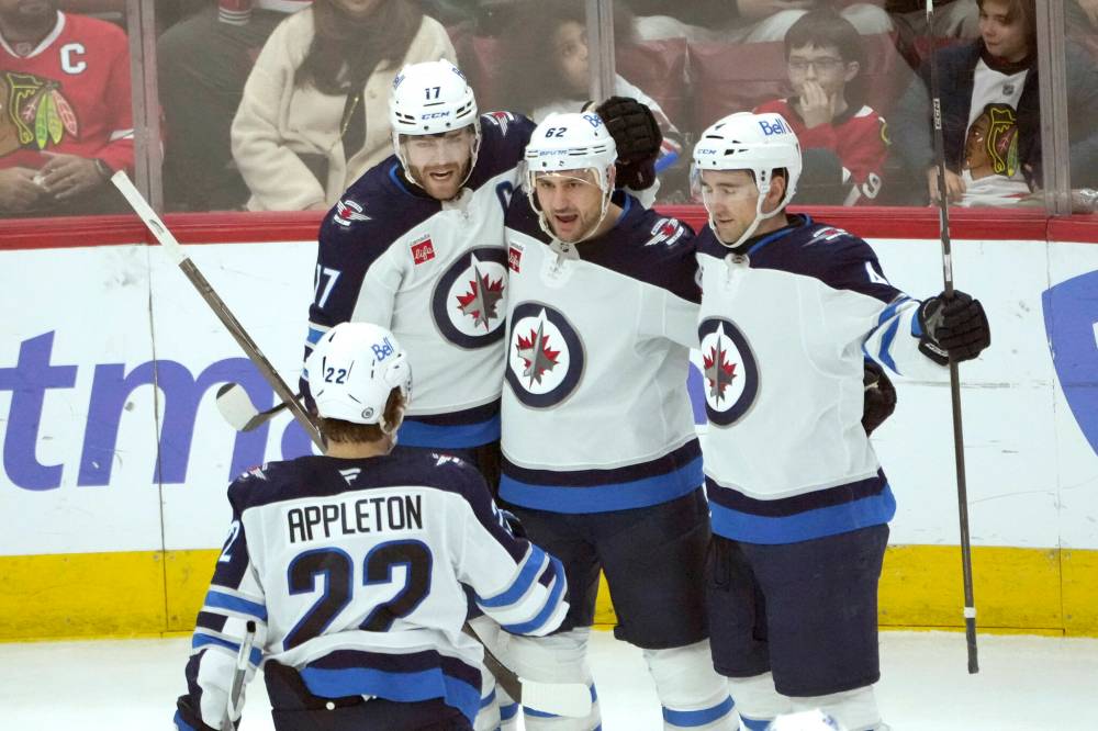 CHARLES REX ARBOGAST / THE ASSOCIATED PRESS
Winnipeg Jets’ Nino Niederreiter (62) celebrates his goal with teammates during the second period of an NHL game against the Chicago Blackhawks on Saturday, Dec. 7, 2024, in Chicago.