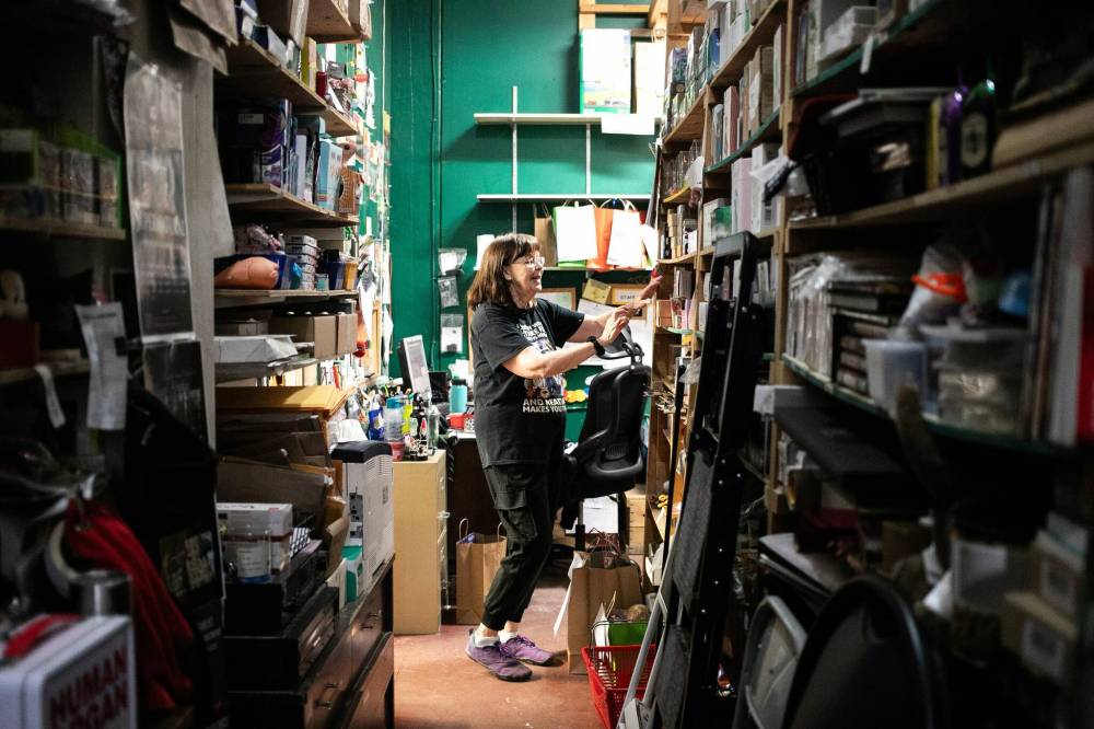MIKAELA MACKENZIE / FREE PRESS
Fonseca, who has worked at Toad Hall Toys for 20 years, looks through stock in the back room.