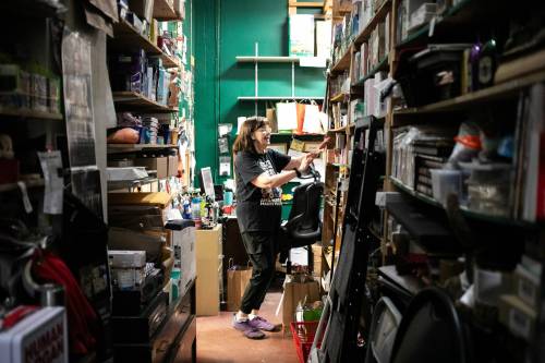 MIKAELA MACKENZIE / FREE PRESS 	 Sue Fonseca, who has worked at Toad Hall Toys for 20 years, looks through stock in the back rooom at the store on Wednesday, Dec. 11, 2024. The store is scrambling to adjust the computerized inventory management system ahead of the upcoming GST holiday. For Scott Billeck story. Winnipeg Free Press 2024