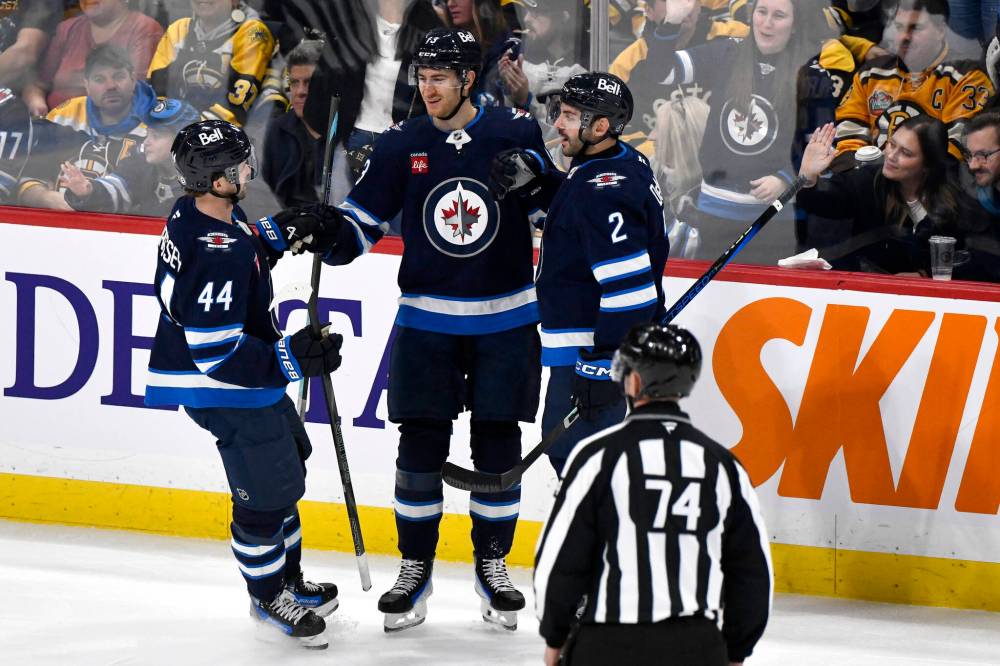 Fred Greenslade / THE CANADIAN PRESS
Gabriel Vilardi (centre) celebrates his third-period goal against the Boston Bruins on Tuesday with Josh Morrissey (left) and Dylan Demelo.