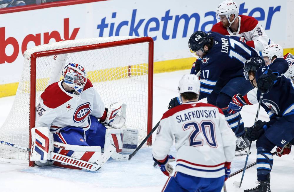 JOHN WOODS / THE CANADIAN PRESS
Winnipeg’s Adam Lowry (17) scores on Canadiens goaltender Sam Montembeault (35) during first-period action in Winnipeg Saturday.