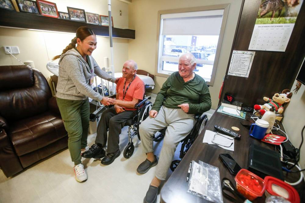 JOHN WOODS / FREE PRESS
                                David Sawatzky (centre) is helped by nurse Cherry Ponc with Wilhelm Funk at right at the Niverville Heritage Centre, which usually has a wait list of about two dozen people.