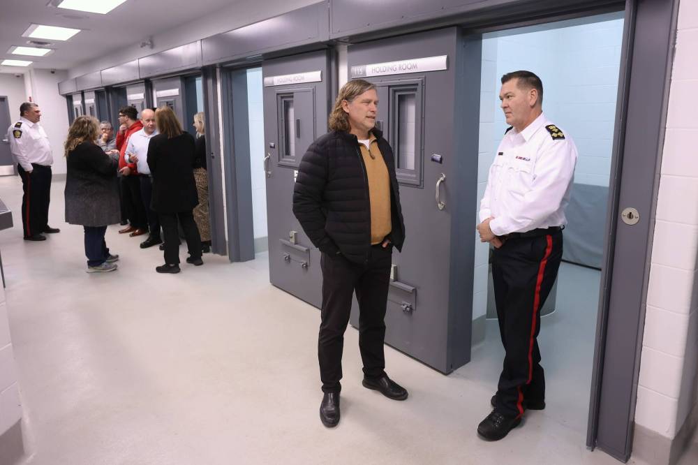 Brandon Mayor Jeff Fawcett (left) chats with Brandon Police Service Chief Tyler Bates while touring the new detention cells at the Brandon Police Service headquarters on Thursday. (Tim Smith / The Brandon Sun)
