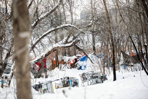 MIKAELA MACKENZIE / FREE PRESS 	 An encampment along the river near Waterfront Drive in Winnipeg on Monday, Dec. 23, 2024. In a year-end interview with CBC, premier Wab Kinew said he would start moving people out of encampments and into housing in the new year. For Malak story. Winnipeg Free Press 2024
