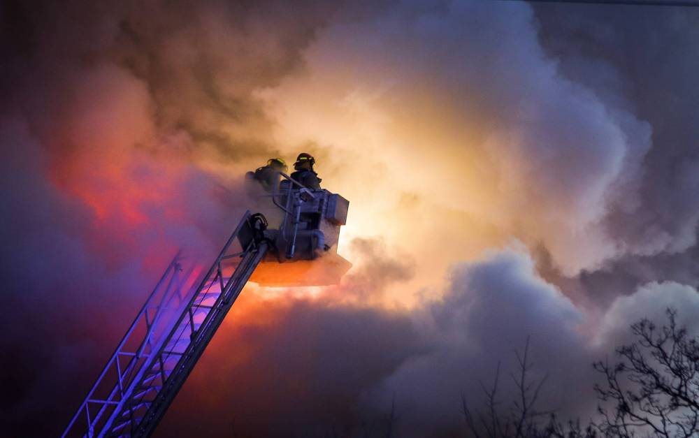 JOHN WOODS / FREE PRESS FILES
Firefighters battle a West End apartment blaze in March.