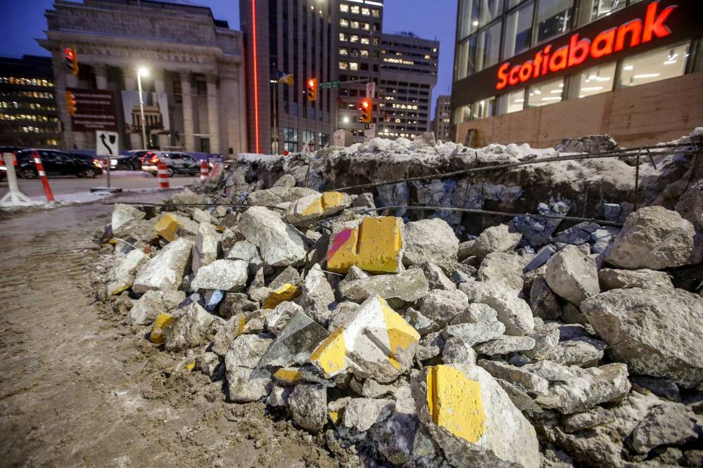 JOHN WOODS / FREE PRESS FILES
Rubble piles up as the demolition of the Portage and Main barricades begins in December.