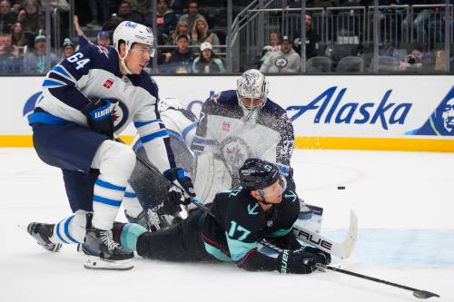 LINDSEY WASSON / THE ASSOCIATED PRESS FILES
                                Winnipeg Jets defenseman Logan Stanley, left, and goaltender Connor Hellebuyck, back center, collide with Seattle Kraken center Jaden Schwartz (17) as they stop his run on the goal during the second period of an NHL hockey game Thursday, Oct. 24, 2024, in Seattle.