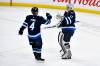 FRED GREENSLADE / THE CANADIAN PRESS
                                Jets’ goaltender Connor Hellebuyck celebrates regular-season victory number 299 and his fifth shutout of the season Monday night with blue-liner Neal Pionk.