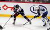 Colorado Avalanche center Casey Mittelstadt, left, collects the puck as Winnipeg Jets center Cole Perfetti defends in the third period of Tuesday’s game. (David Zalubowski/ The Associated Press)