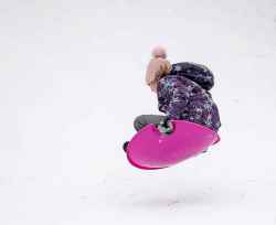BROOK JONES/FREE PRESS
Josphine PIche, 9, who lives in St. Vital, goes airborn on a plastic saucer as she hits a bump while sliding down the stream bank at Omand's Creek on Christmas Day in Winnipeg, Man., Wednesday, Dec. 25, 2024.