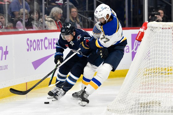 St. Louis Blues' Pierre-Olivier Joseph (77) checks Winnipeg Jets' Cole Perfetti (91) during Tuesday's game in Winnipeg. The Jets are coming off a 4-1 loss to the Blues as they face the Sabres. (Fred Greenslade / The Canadian Press files)