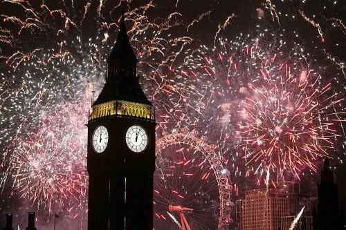 Fireworks light up the sky over Elizabeth Tower, also known as Big Ben, and the London Eye in central London during the New Year celebrations Wednesday Jan. 1, 2025. (James Manning/PA via AP)