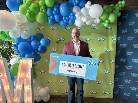 Matthew Tannas shows off his big lottery win, one of the largest prizes ever won by a Manitoban. (Supplied)