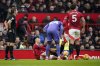 Manchester United's Lisandro Martinez holds his knee after an injury during the English Premier League soccer match between Manchester United and Crystal Palace at Old Trafford stadium in Manchester, England, Sunday, Feb. 2, 2025. (AP Photo/Dave Thompson)