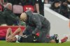 Tottenham's Richarlison gets treatment before leaving the field injured during the English League Cup semifinal second leg soccer match between Liverpool and Tottenham Hotspur at Anfield Stadium in Liverpool, England, Thursday, Feb. 6, 2025. (AP Photo/Jon Super)