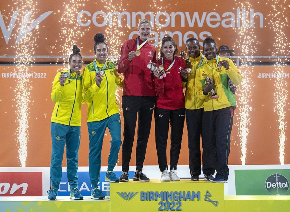 Sarah Pavan, left, and Melissa Humana-Paredes of Canada are flanked by silver medallists Mariafe Artacho del Solara and Taliqua Clancy, left, from Australia and Miller Pata and Sherysyn Toko of Vanuatu, bronze medallists,  at  the women's beach volleyball competition at the Commonwealth Games in Birmingham, England on Sunday, Aug. 7, 2022.. THE CANADIAN PRESS/Andrew Vaughan