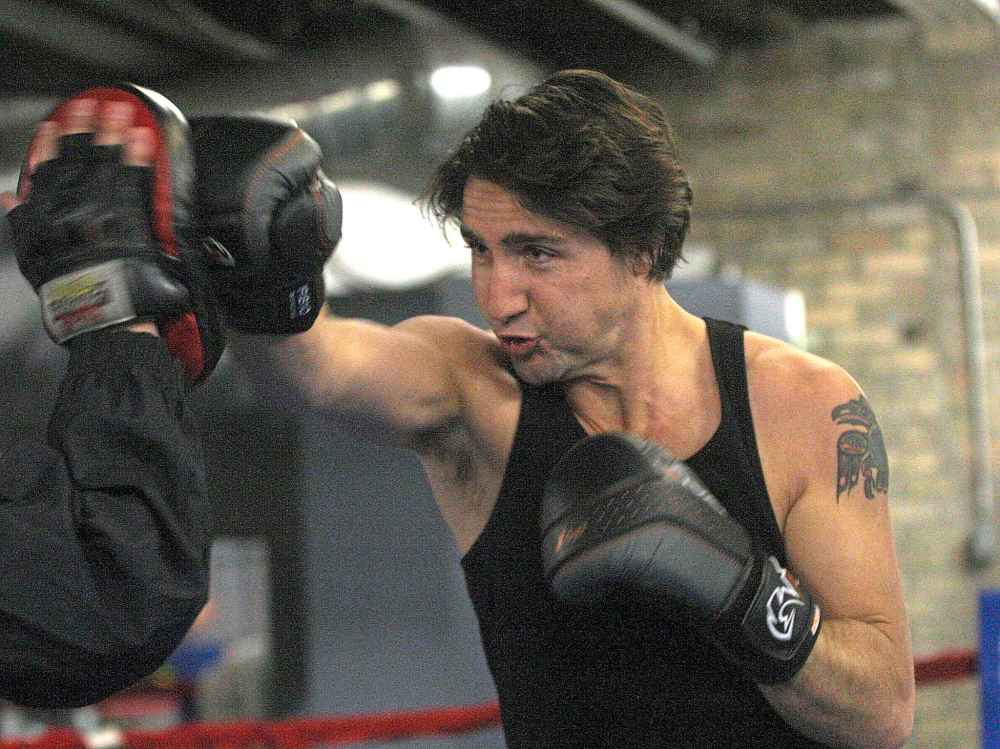 Trudeau working out with Pan Am Boxing Club owner Harry Black ahead of a leadership candidate debate in Winnipeg in 2013. (Joe Bryksa / Free Press files)