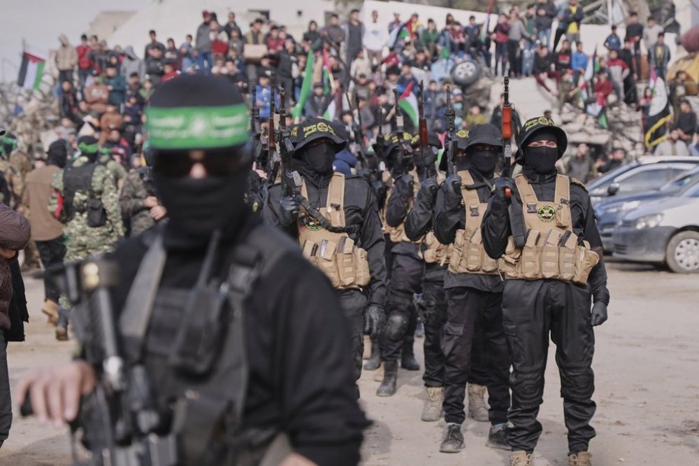 Hamas and Islamic Jihad fighters are deployed in central Gaza City ahead of the planned release of four Israeli female hostages set to be handed over to the Red Cross in Gaza City on Saturday, Jan. 25, 2025. (AP Photo/Abed Hajjar)