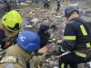 In this photo provided by the Ukrainian Emergency Service, firefighters clear the rubble and search for victims in a ruined apartment building following a Russian rocket attack in Poltava, Ukraine, Saturday, Feb. 1, 2025. (Ukrainian Emergency Service via AP)