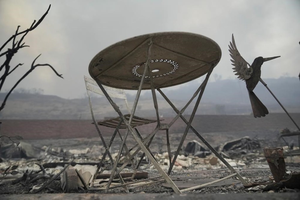 The Palisades Fire ravages a neighborhood amid high winds in the Pacific Palisades neighborhood of Los Angeles, Wednesday, Jan. 8, 2025. (AP Photo/Damian Dovarganes)