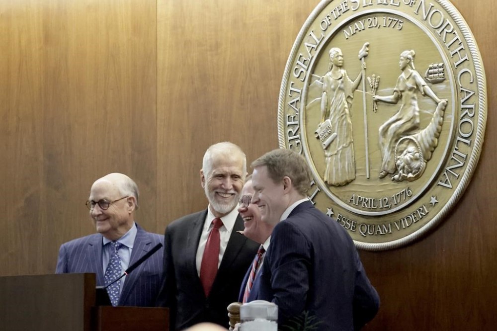 North Carolina House Speaker Destin Hall, R-Caldwell, right, is joined by former Republican Speakers Harold Brubaker, left, U.S. Senator Thom Tillis, second from left, and U.S. House member Tim Moore, second from right, after he took the oath of office at the Legislative Building, Wednesday, Jan. 8, 2025, in Raleigh, N.C. (AP Photo/Chris Seward)
