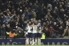 Tottenham's Lucas Bergvall celebrates with teammates after scoring the opening goal during the English League Cup semi final first leg soccer match between Tottenham and Liverpool, at the Tottenham Hotspur Stadium in London, Wednesday, Jan. 8, 2025. (AP Photo/Ian Walton)