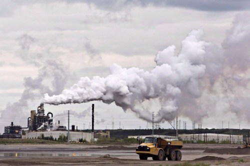 A dump truck works near the Syncrude oil sands extraction facility near the city of Fort McMurray, Alberta on Sunday June 1, 2014. THE CANADIAN PRESS/Jason Franson
