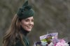 Kate Princess of Wales smiles as holds a bouquet of flowers gives to her by well-wishers after she attended the Christmas day service at St Mary Magdalene Church in Sandringham in Norfolk, England, Wednesday, Dec. 25, 2024. (AP Photo/Jon Super)
