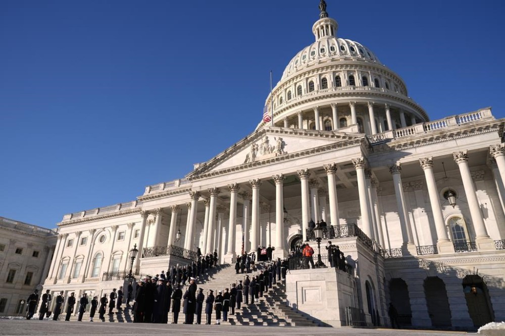 A joint services body bearer team carries the flag-draped casket of former President Jimmy Carter from the U.S. Capitol in Washington, Thursday, Jan. 9, 2025, to head to Washington National Cathedral for a State Funeral. (AP Photo/Susan Walsh, Pool)