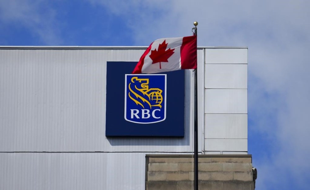 RBC says it has partnered with Cohere to co-develop generative artificial intelligence products for the financial industry. A Royal Bank of Canada sign and a Canadian flag are pictured in Ottawa on Thursday, June 27, 2024. THE CANADIAN PRESS/Sean Kilpatrick