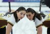Manitoba third Karlee Burgess, left, and second Mackenzie Zacharias sweep while playing Team Wildcard 3 at the Scotties Tournament of Hearts, in Kamloops, B.C., on Sunday, February 19, 2023. The mid-season departure of Burgess from Team Chelsea Carey to fill an opening on Team Kerri Einarson was just the latest example of an unusual curling roster change late in the quadrennial.THE CANADIAN PRESS/Darryl Dyck