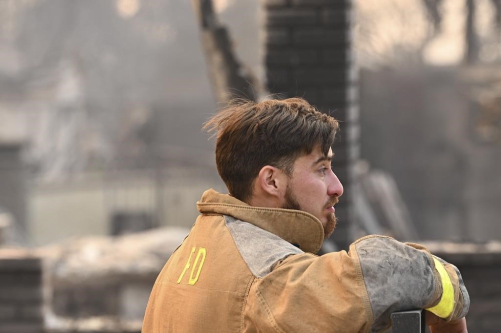 Robert Lara looks through his home that was destroyed after the Eaton Fire burns in Altadena, Calif., Thursday, Jan. 9, 2025. (AP Photo/Nic Coury)