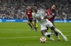 Real Madrid's Rodrygo is challenged by Mallorca's Pablo Maffeo, right, during the Spanish Super Cup semifinal soccer match between Real Madrid and Mallorca at the King Abdullah Stadium in Jeddah, Saudi Arabia, Thursday, Jan. 9, 2025. (AP Photo/Altaf Qadri)