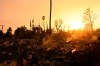 The sun sets over damage from the Eaton Fire, Thursday, Jan. 9, 2025, in Altadena, Calif. (AP Photo/Nic Coury)