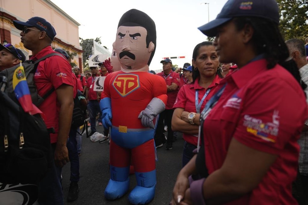 A government supporter dressed as Super Mustache, a character depicting President Nicolas Maduro as a superhero, stands outside of Miraflores Palace after a rally, days ahead of Maduro's presidential inauguration for a third term in Caracas, Venezuela, Wednesday, Jan 8, 2025. (AP Photo/Ariana Cubillos)
