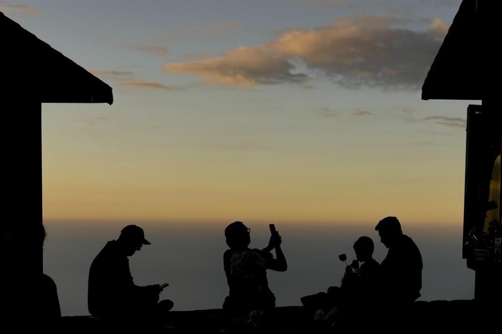 A family gathers on top of a mountain in El Avila National Park in La Guaira, Venezuela, Wednesday, Jan. 8, 2025, days ahead of President Nicolas Maduro's inauguration for a third presidential term. (AP Photo/Matias Delacroix)