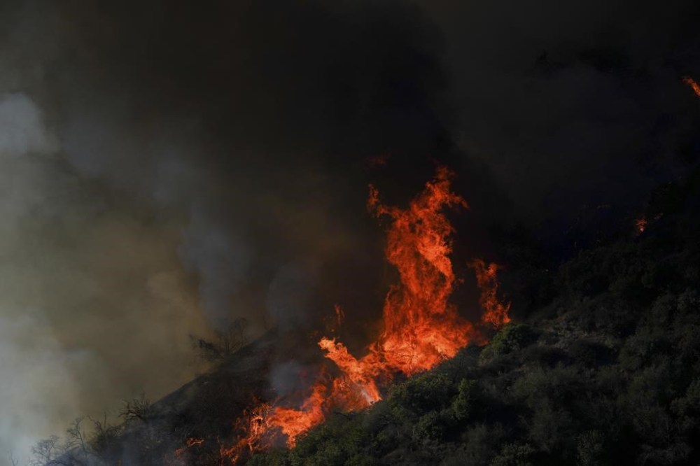 The Palisades Fire continues to burn in the outskirts of the Pacific Palisades neighborhood of Los Angeles, Friday, Jan. 10, 2025. (AP Photo/Eric Thayer)