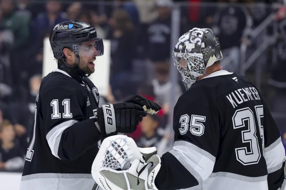 Los Angeles Kings center Anze Kopitar, left, speaks with goaltender Darcy Kuemper after the team's win against the New Jersey Devils during an NHL hockey game, Wednesday, Jan. 1, 2025, in Los Angeles. THE CANADIAN PRESS/AP-Ryan Sun