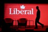 A stagehand works on the stage in between presenters at the 2023 Liberal National Convention in Ottawa, on Thursday, May 4, 2023. THE CANADIAN PRESS/Justin Tang