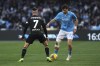 Napoli's Khvicha Kvaratskhelia, right, and Venezia's Francesco Zampano in action during the Serie A soccer match between Napoli and Venezia at the Diego Armando Maradona Stadium in Naples, Italy Sunday Dec. 29, 2024. (Alessandro Garofalo/LaPresse via AP)