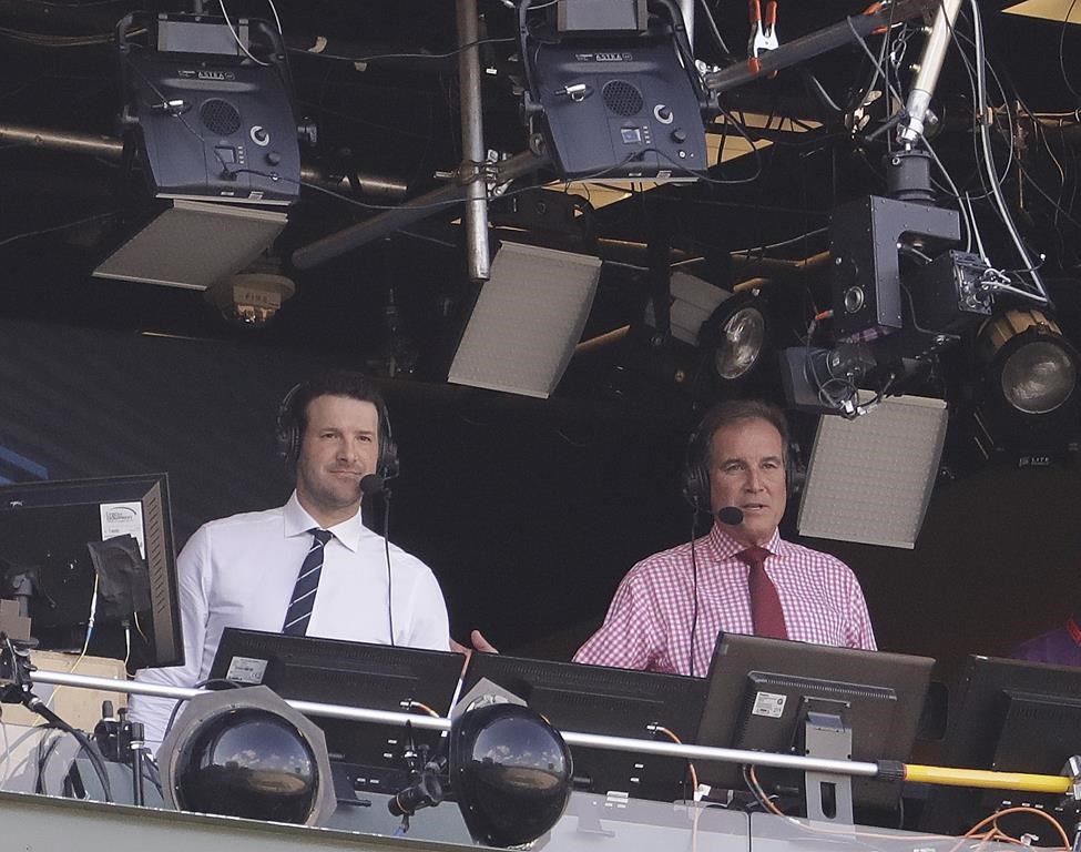 FILE - Tony Romo, left, and Jim Nantz work in the broadcast booth before an NFL football game between the Green Bay Packers and the Cincinnati Bengals Sunday, Sept. 24, 2017, in Green Bay, Wis. (AP Photo/Morry Gash, File)