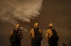 Firefighters watch water drops on the Palisades Fire in Mandeville Canyon on Saturday, Jan. 11, 2025, in Los Angeles. British Columbia’s forests minister says a crew from the province’s wildfire service left for California Saturday afternoon to help battle the wildfires ravaging the Los Angeles area. THE CANADIAN PRESS/AP, Eric Thayer